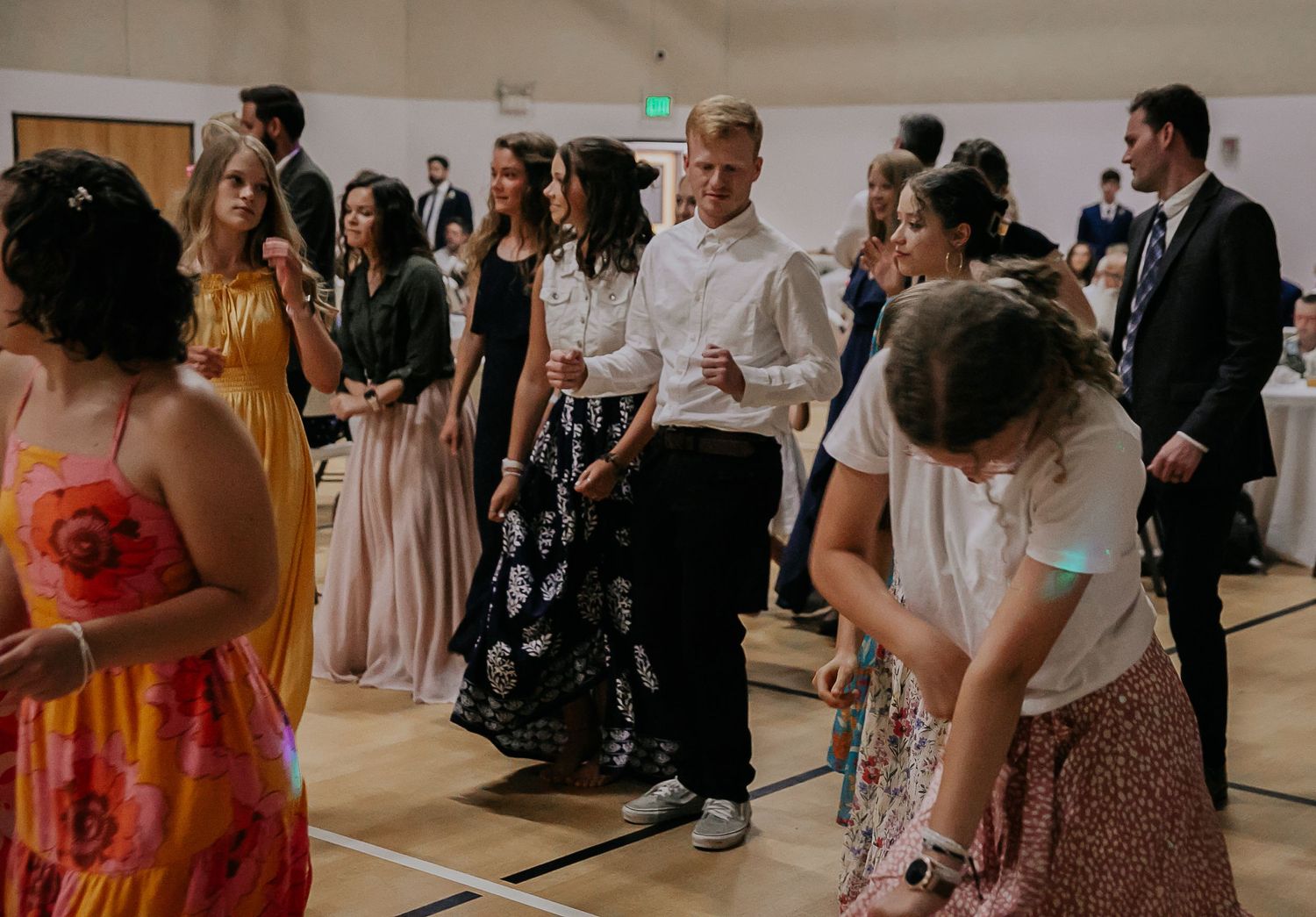 Guests mingling and socializing during an indoor celebration event.