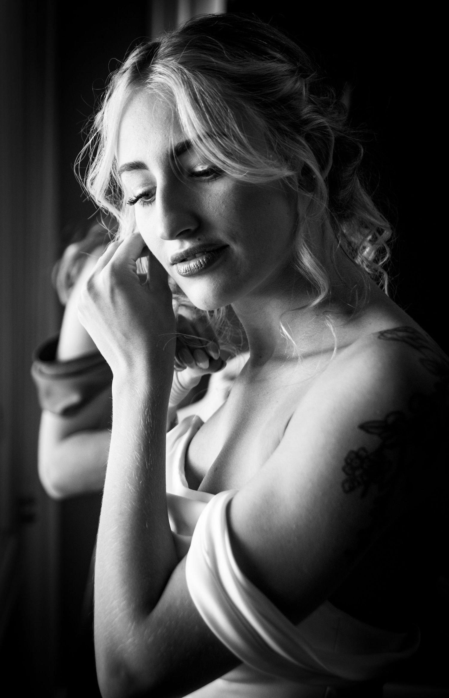Artistic black and white bridal portrait by window light.
