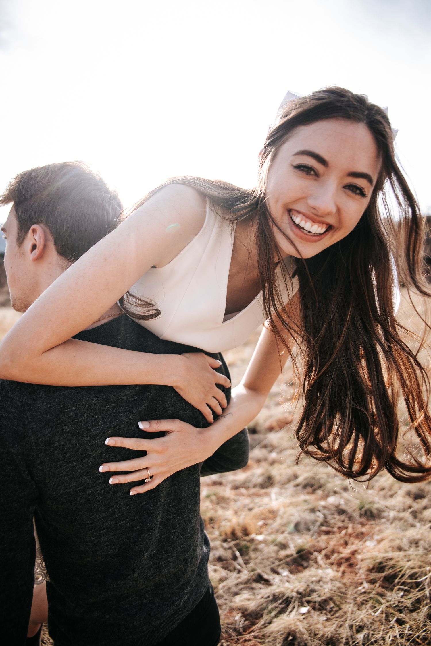 A joyful piggyback ride moment captured in golden hour light.
