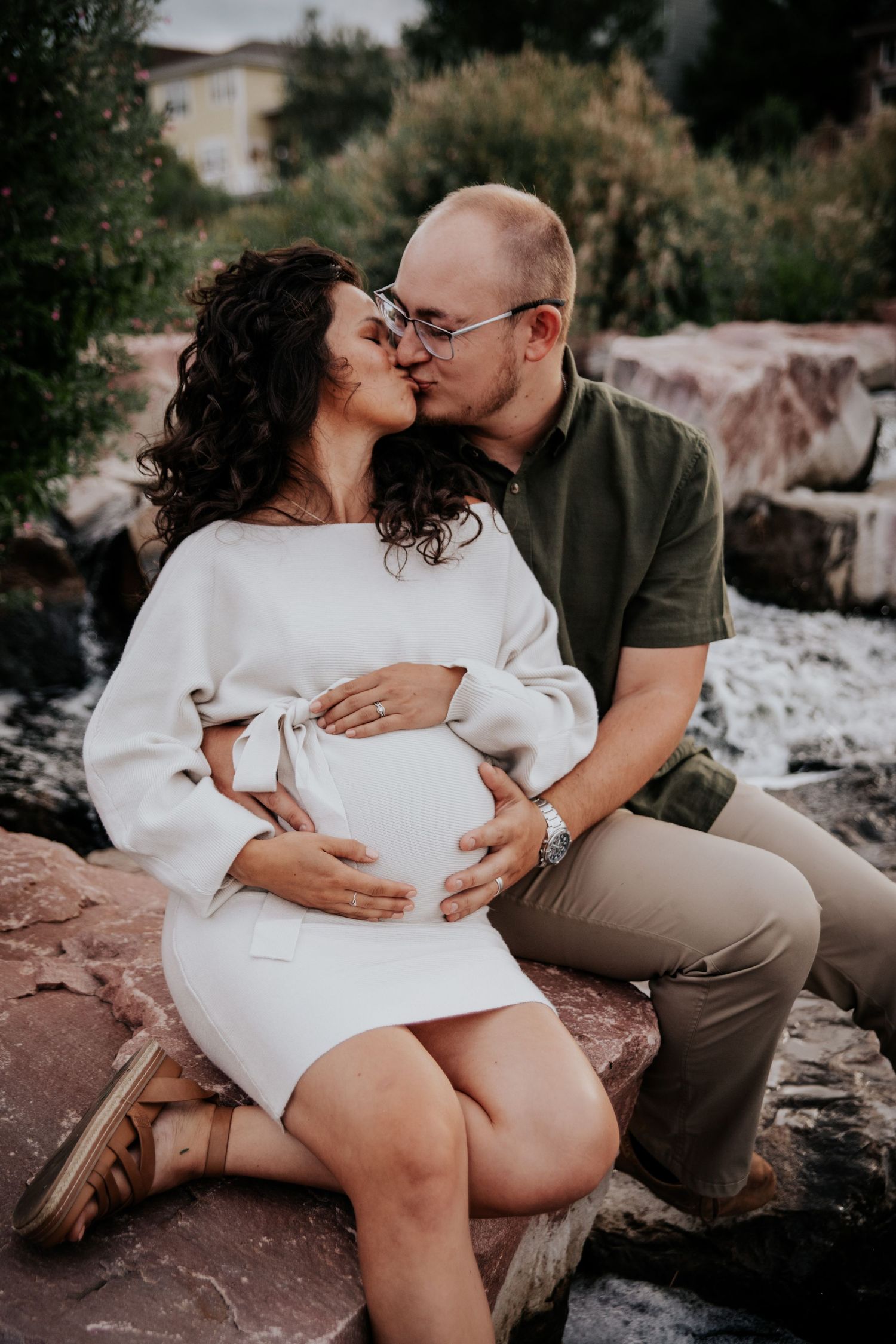 Couple along a waterfall during Colorado Springs maternity photo session