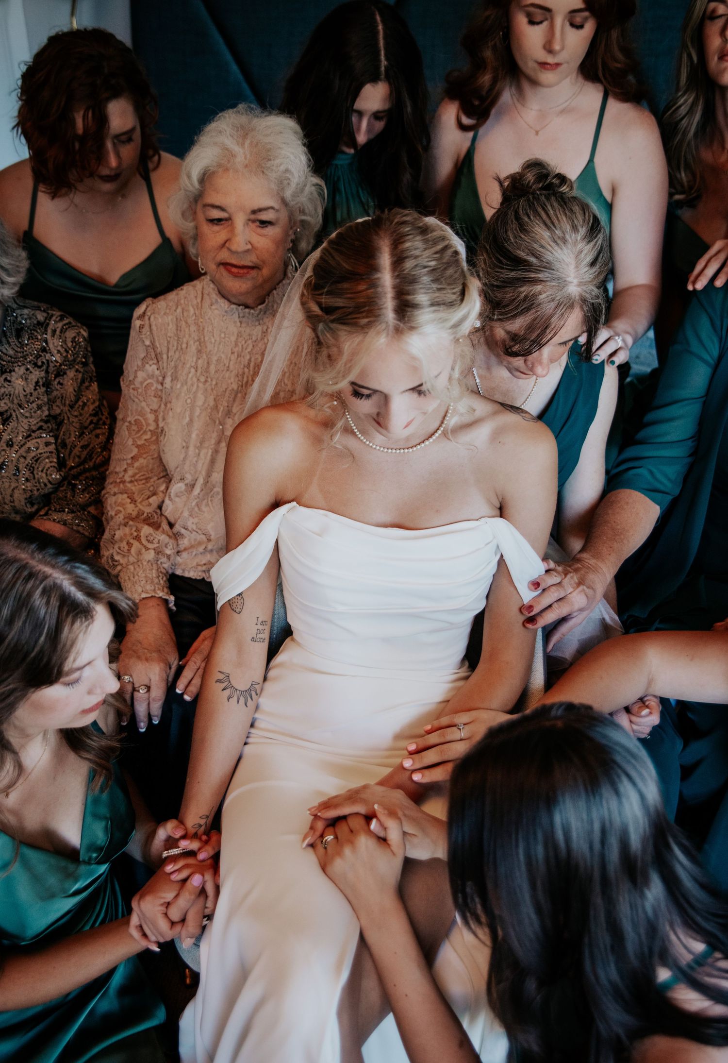 Bridesmaids praying over bride during Palmer Lake wedding near Colorado Springs