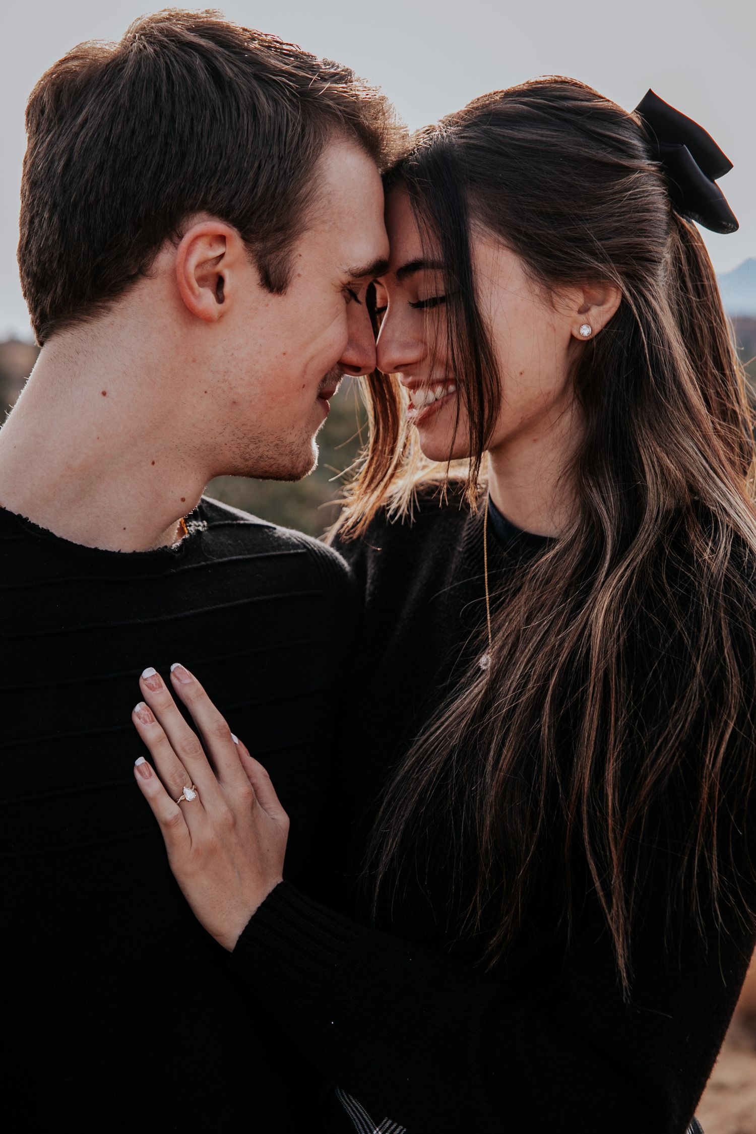 Artistic close-up shots of a couple sharing intimate moments with mountains in the background.