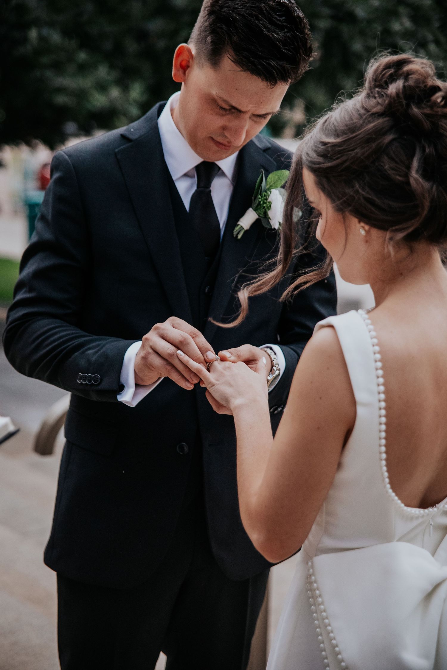 An emotional first look moment between a couple in elegant wedding attire.