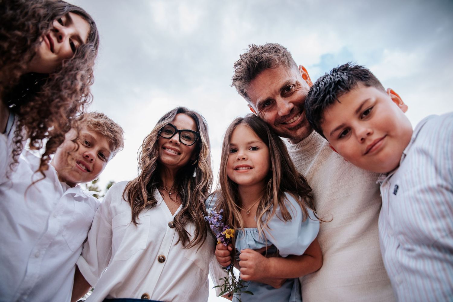 Candid group photo showing joyful expressions during outdoor family photoshoot at Ute Valley Park in Colorado Springs