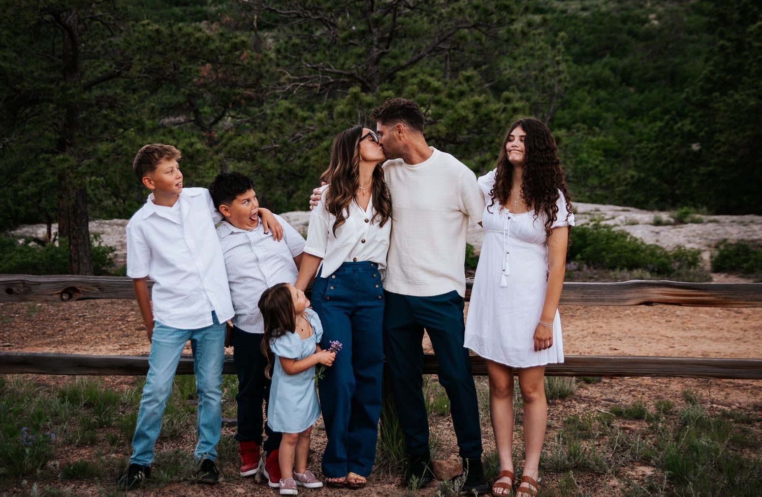 Family photo session panorama with mountains and forest in the background at Ute Valley Park in Colorado Springs