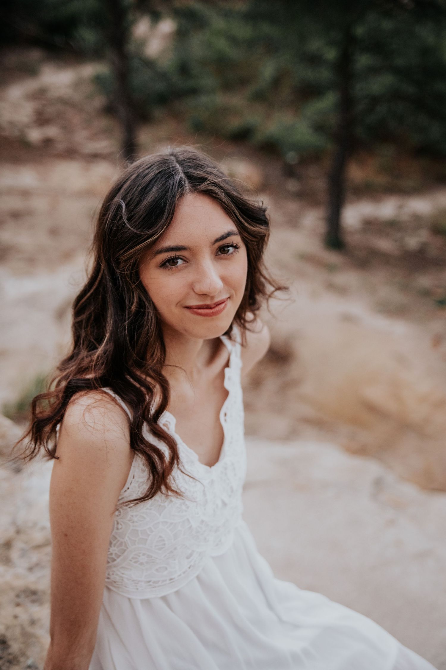 Portrait series showing natural poses against a desert landscape backdrop.