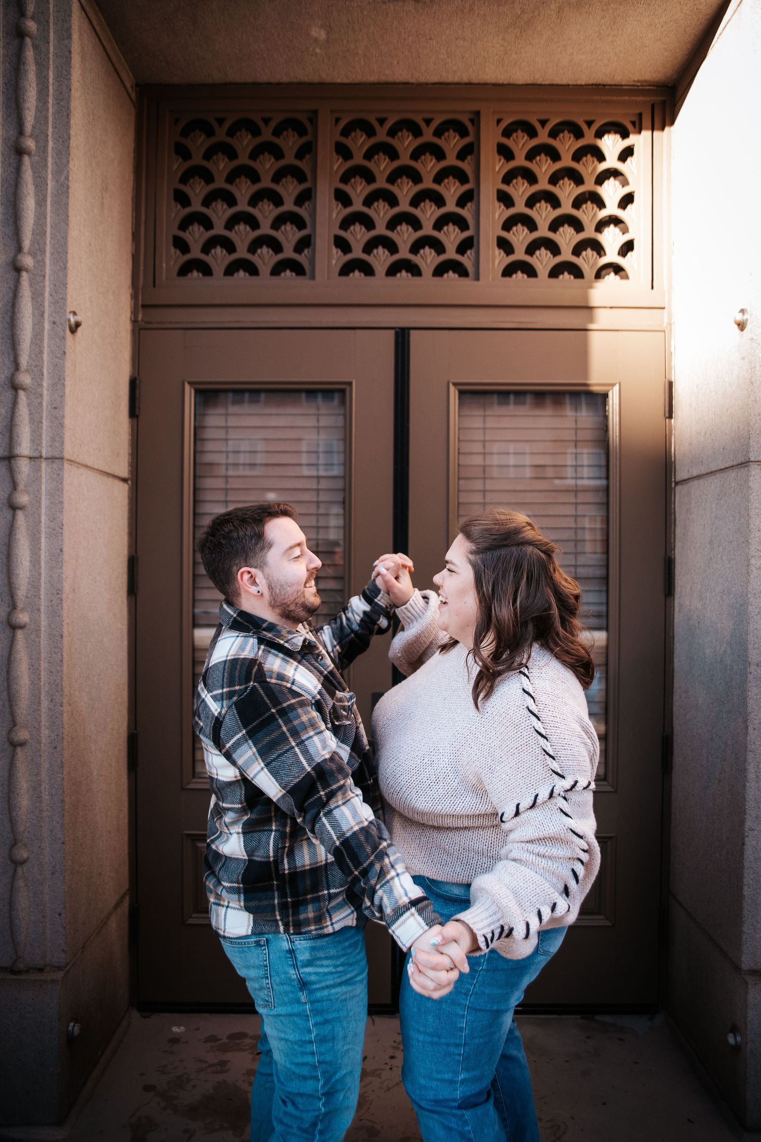 Couple dancing in front of City Hall in Downtown Colorado Springs during engagement photo session