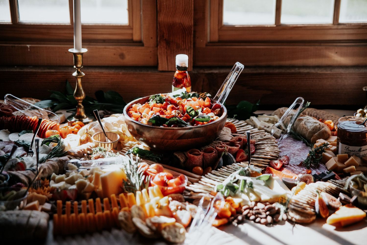 Rustic wedding reception table with elegant appetizers and charcuterie spread.