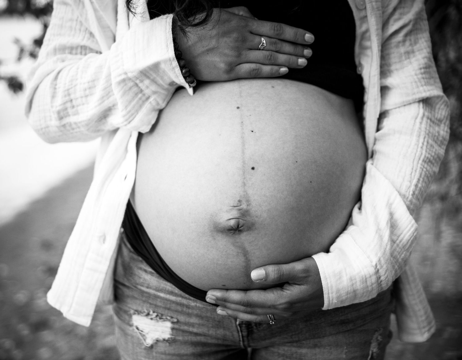 Black and white progression of pregnancy photos showing growing baby bump.