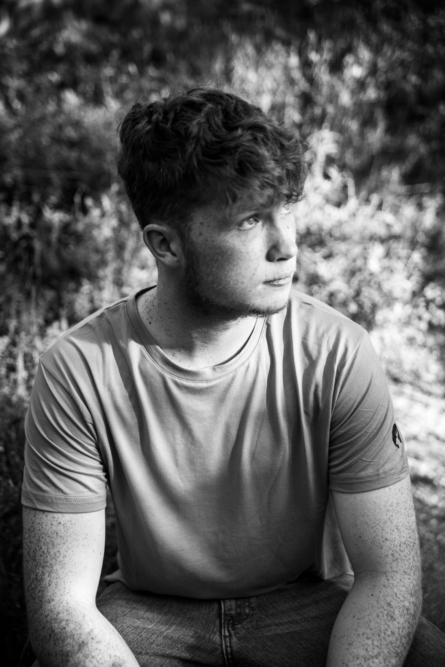 Young man in black and white photo at Red Rock Open Space during senior photo session in Colorado Springs