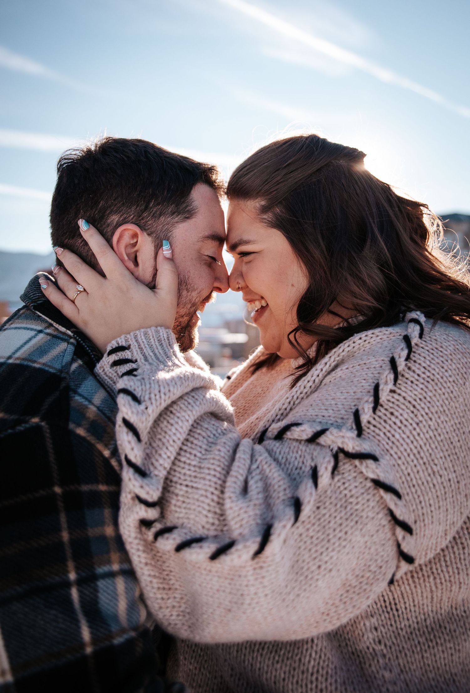 Couple nuzzling during golden hour engagement photo session in Downtown Colorado Springs