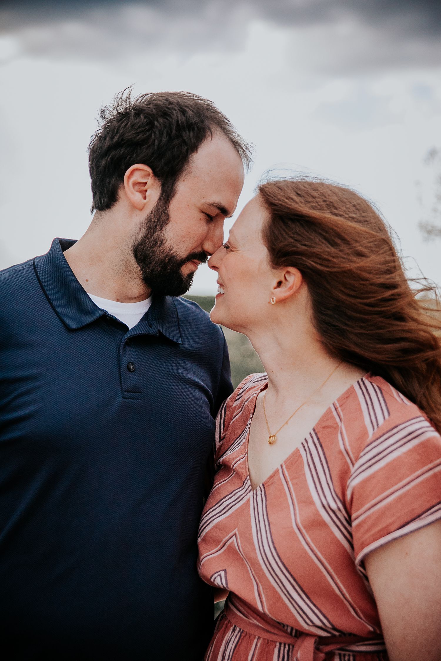 Intimate close-up of romantic couple sharing tender moment outdoors.