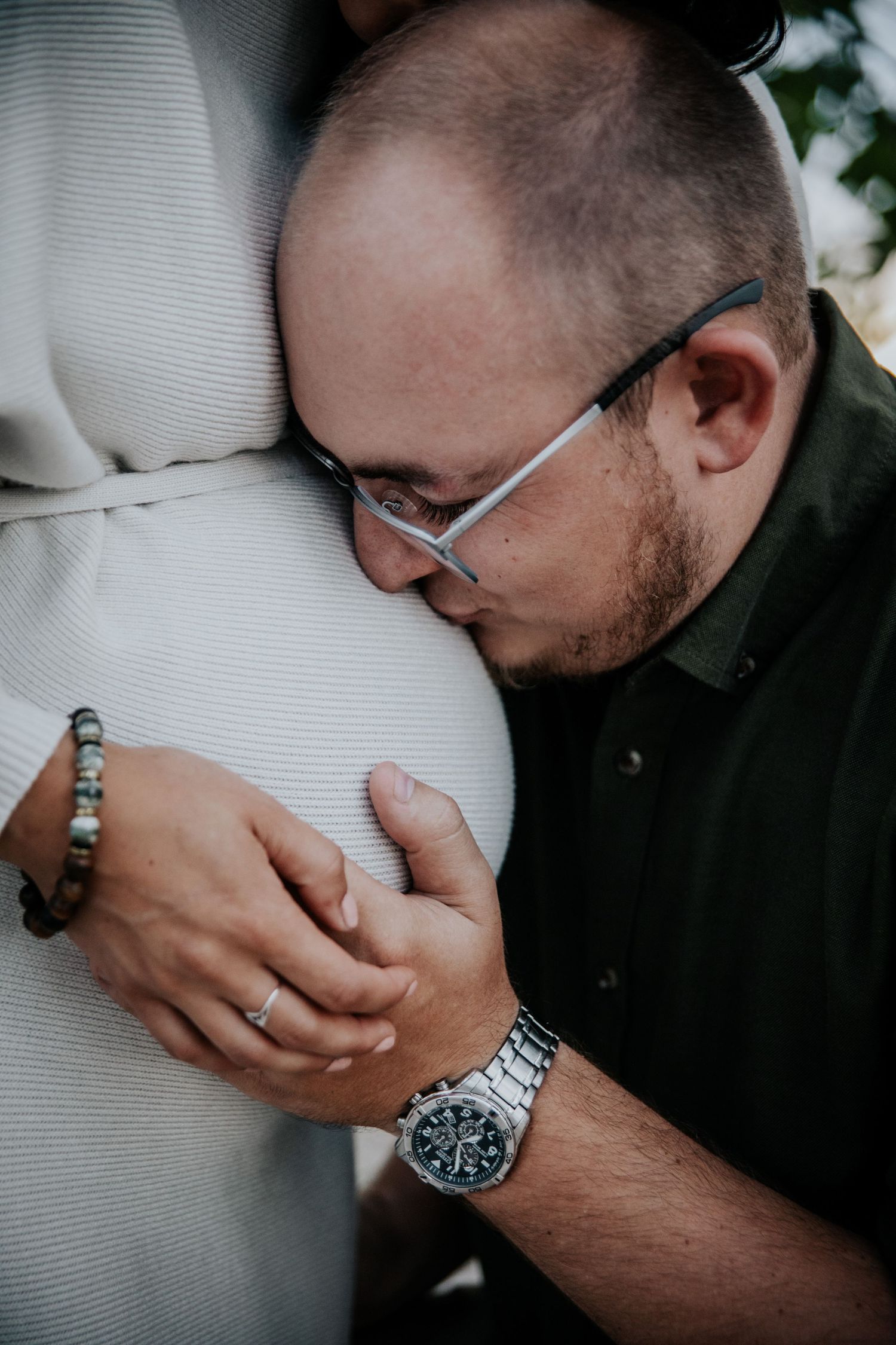 Close-up details of tender moments between a couple during what appears to be a romantic photo shoot.