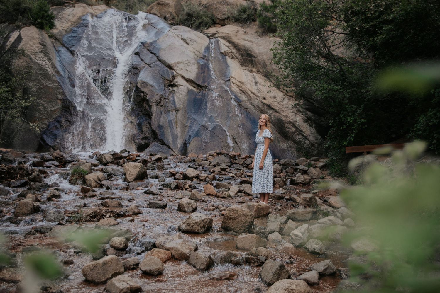 Rocky waterfall landscape with stone formations and natural scenery.