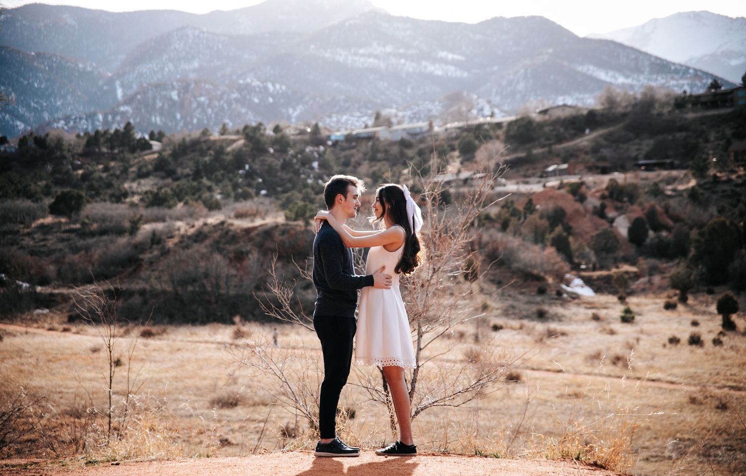 Couple close in front of mountains during engagement photo shoot at Red Rock Open Space in Colorado Springs