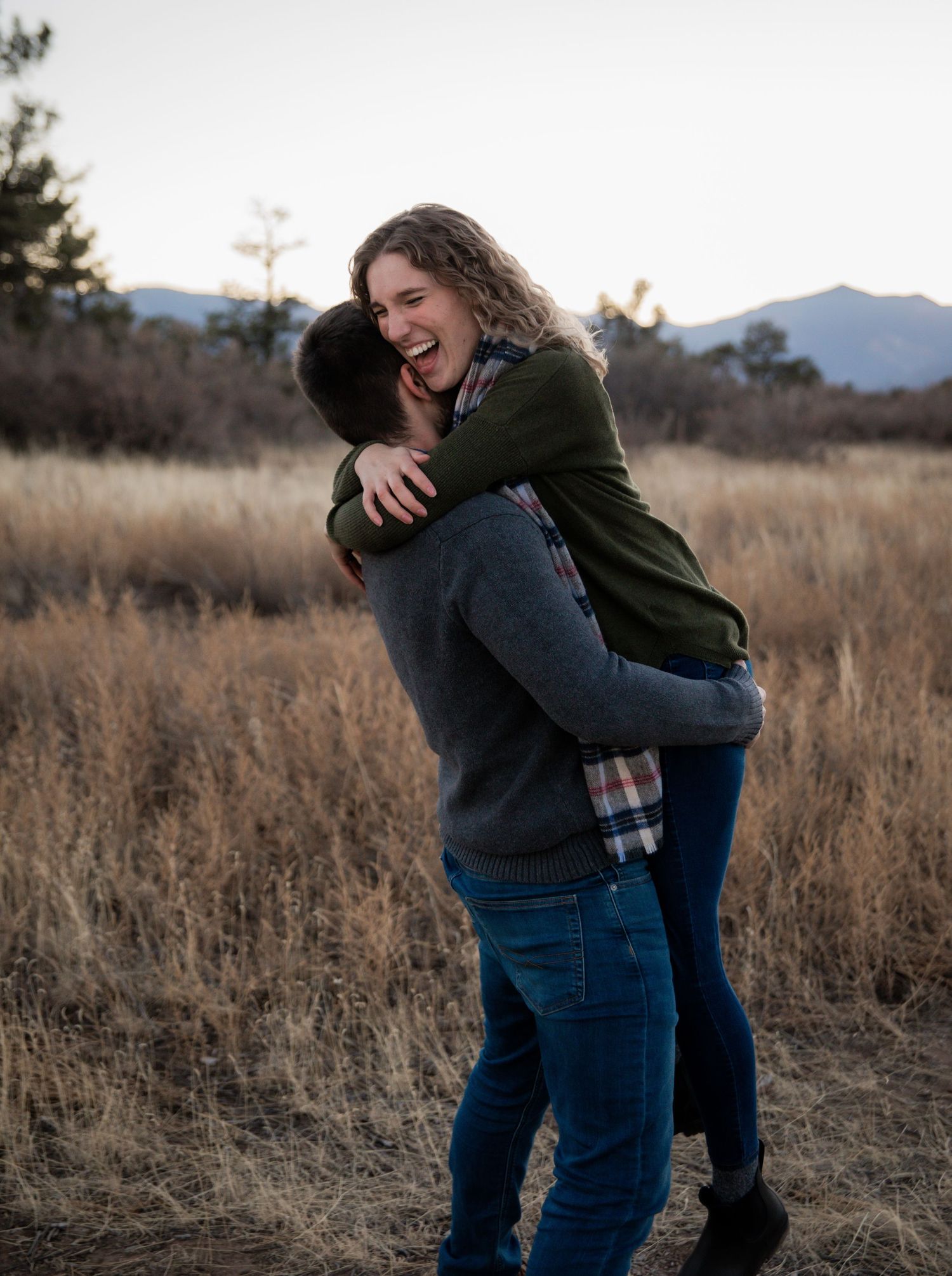 Couple laughing during engagement photography session at Palmer Park in Colorado Springs