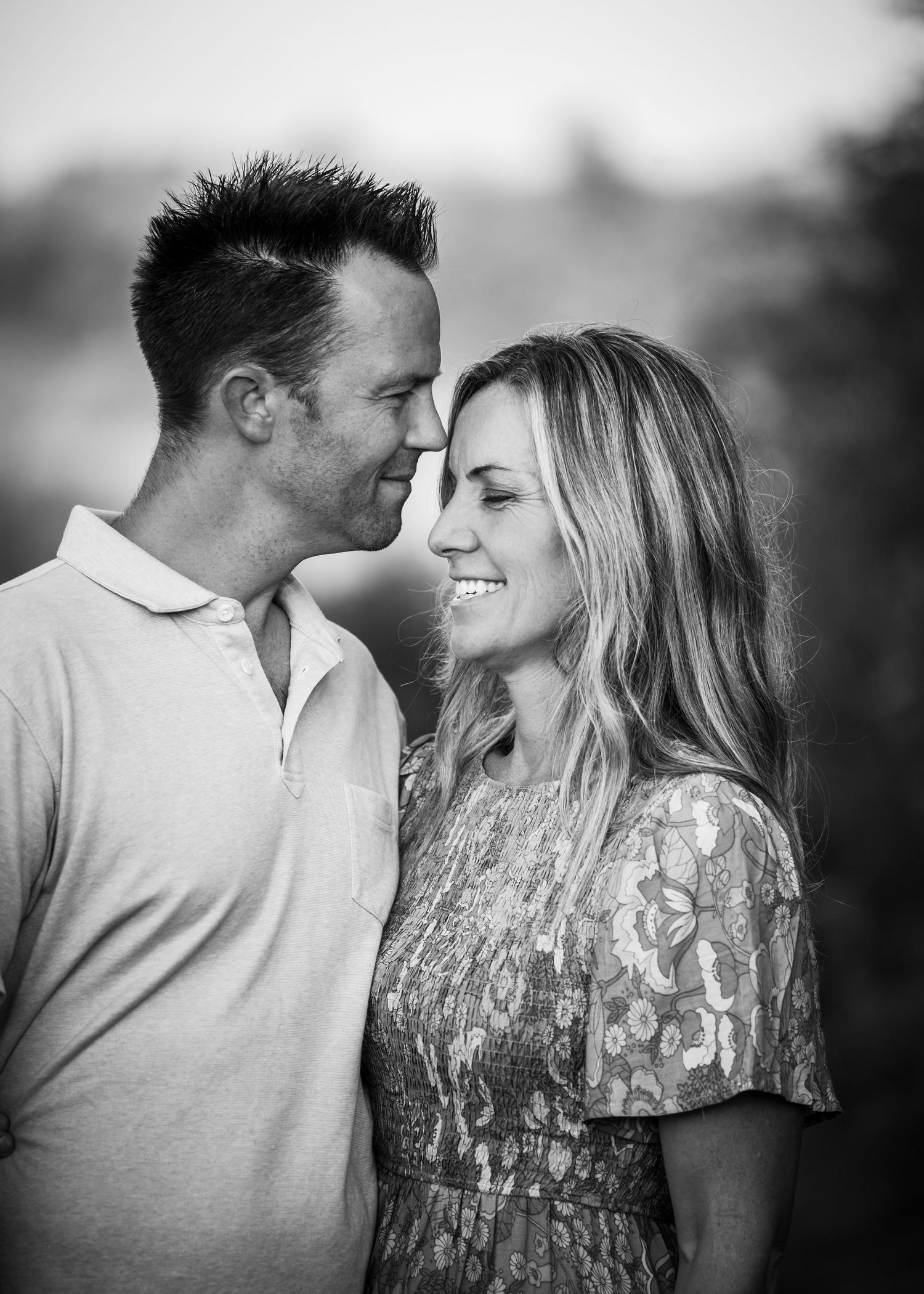 Black and white romantic photo series showing a couple in intimate close-up moments sharing tender expressions.