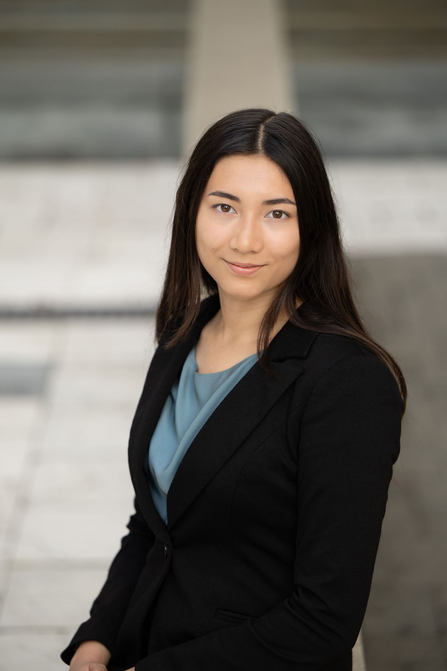 Professional headshot series showing person in black blazer and blue shirt against blurred background.