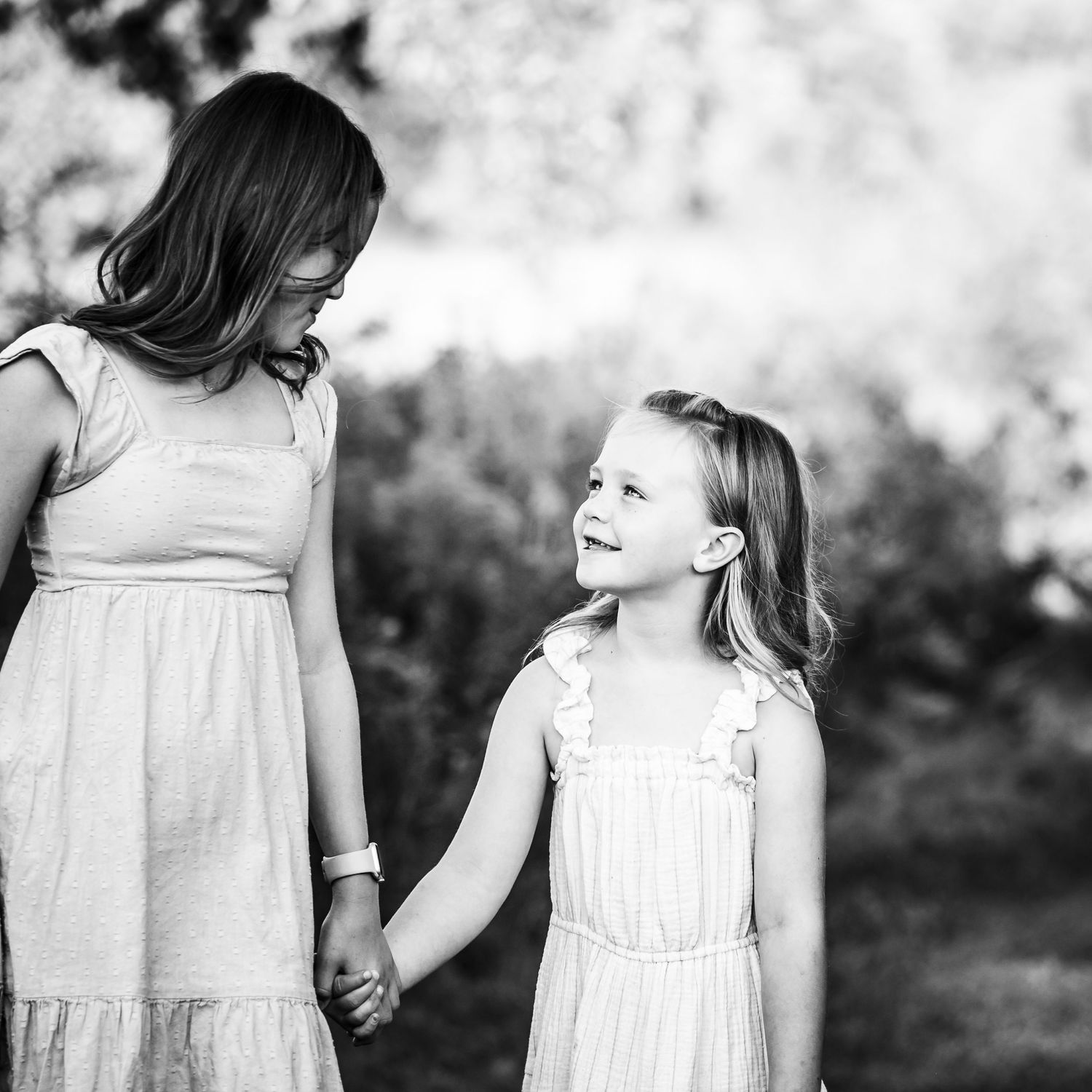 A series of black and white photographs showing a child in a white dress looking in different directions.