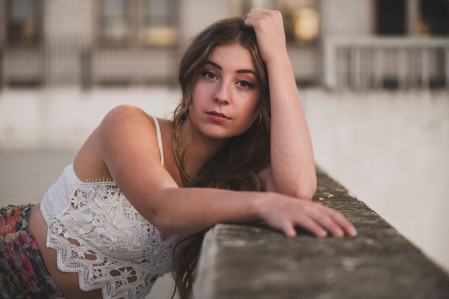 A series of artistic portraits showing someone in a white lace dress posing against a neutral background.
