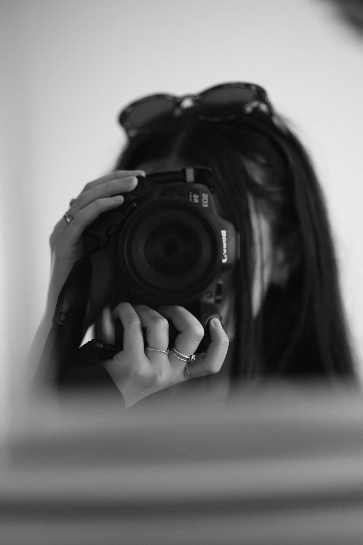 photo of photographer and a canon camera taking photos