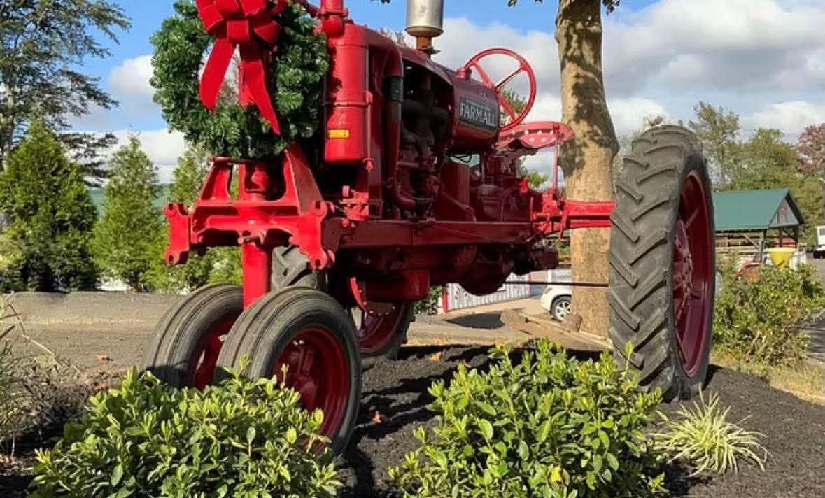 Red Christmas tractor with a wreath at Anne Ellen Farms in Manalapan, NJ