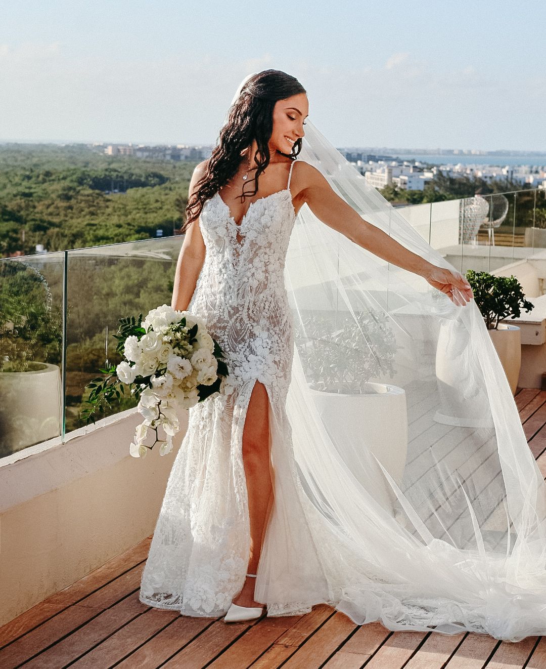A bride celebrating her destination wedding during a beautiful outdoor photo session in Mexico.