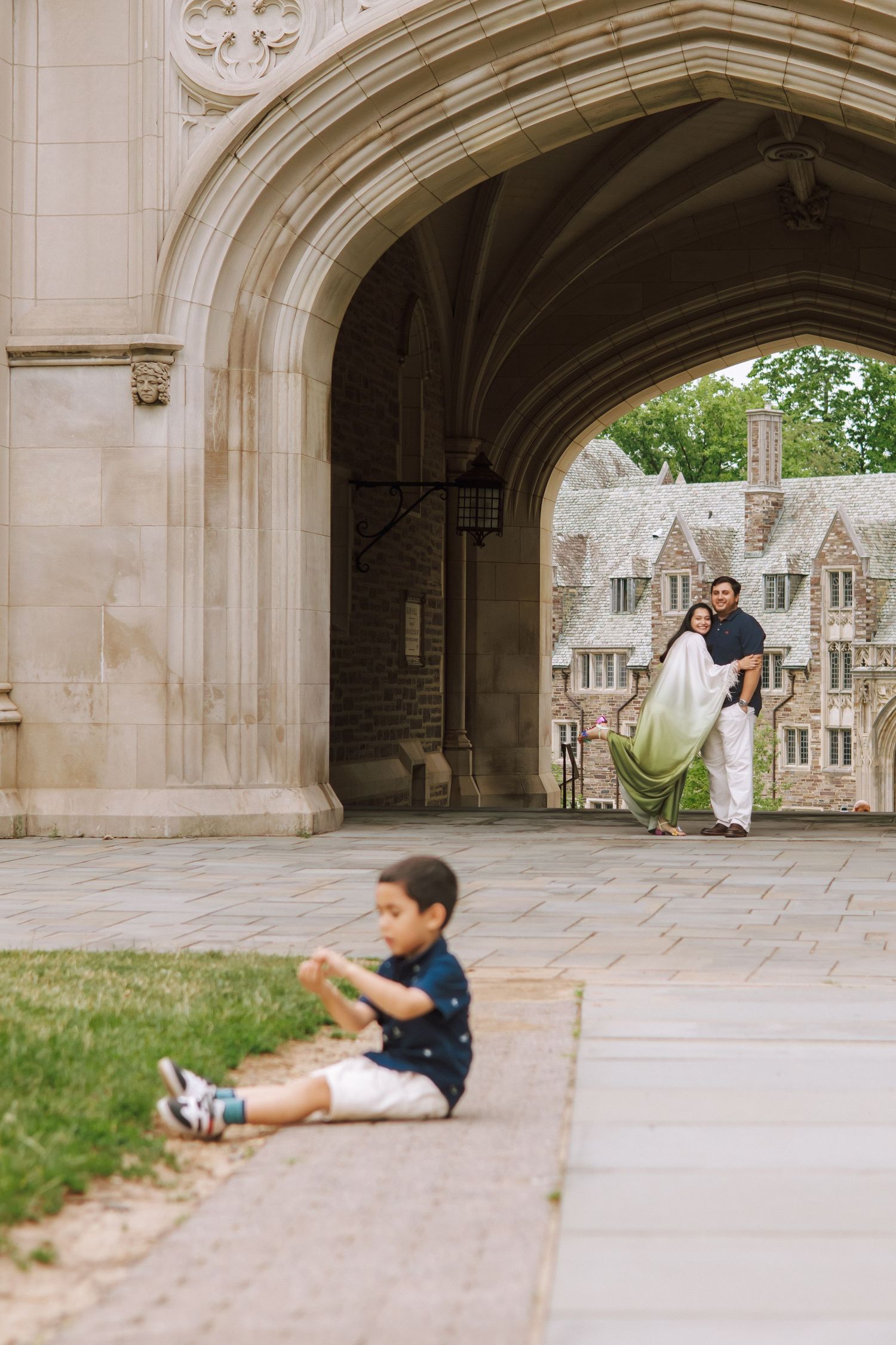 A happy family holding hands and walking together outdoors through the scenic campus grounds at Princeton University in New Jersey.