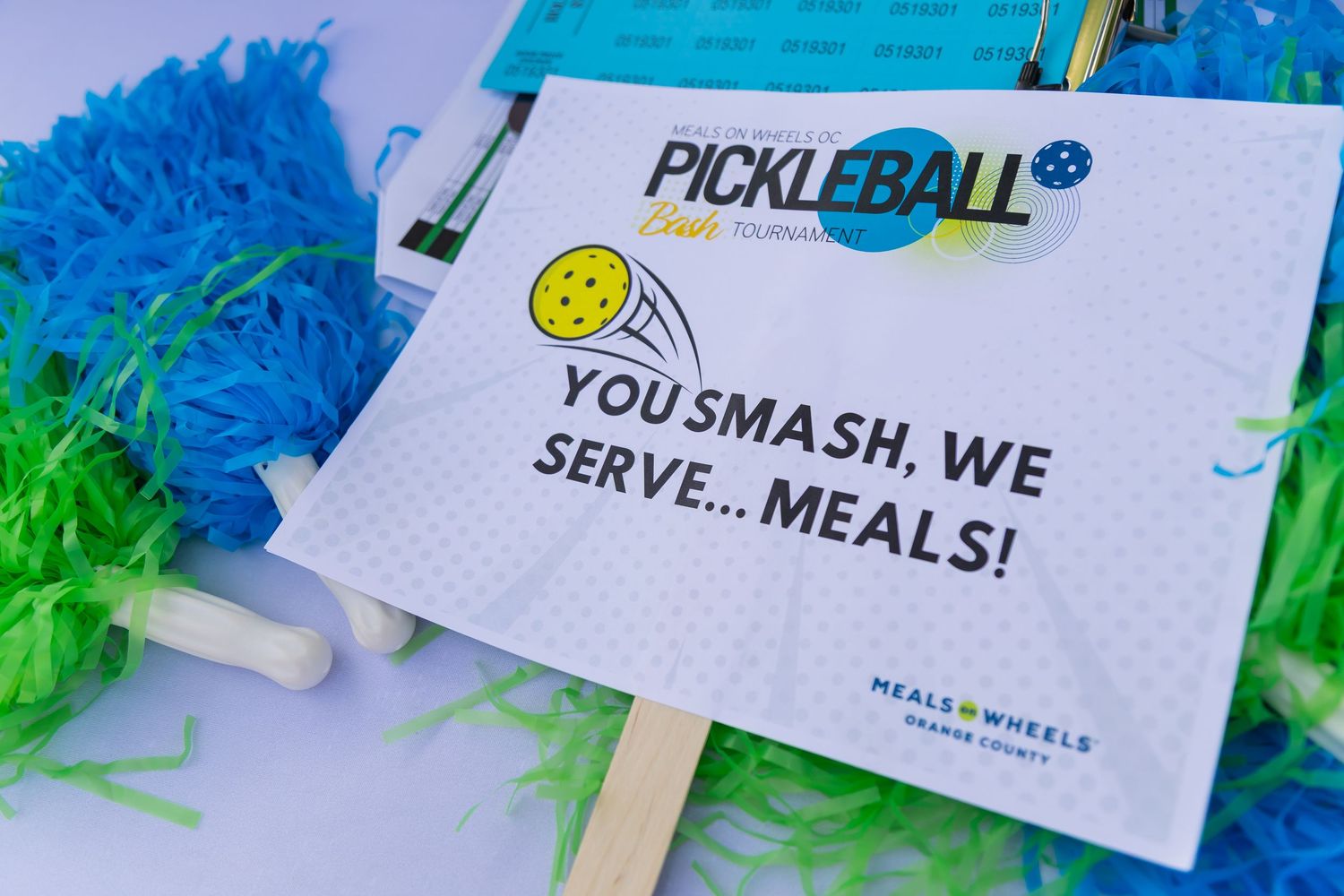 Pickle ball sign with company slogan.