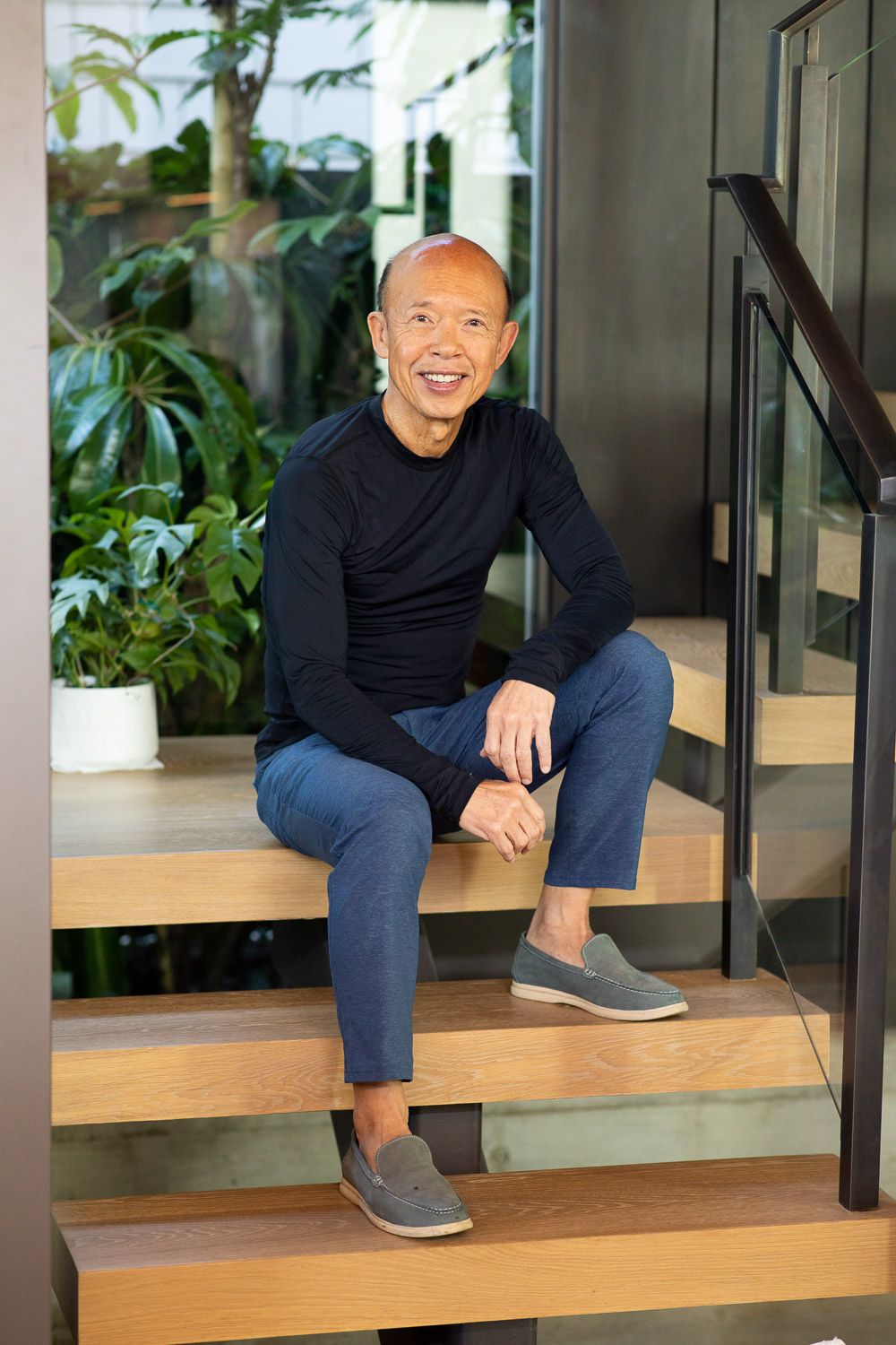 On-location life style portrait of a man sitting on stairway.