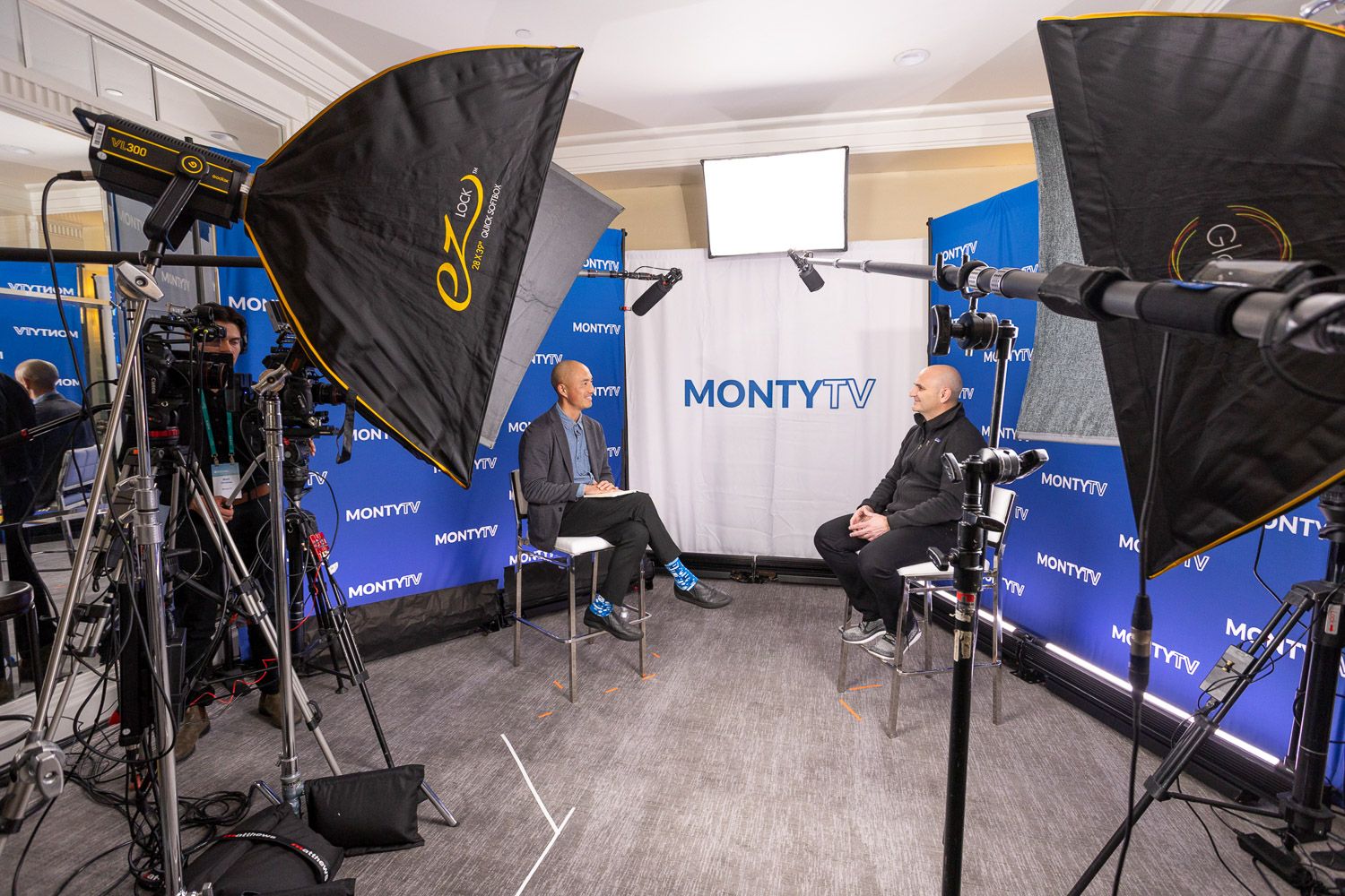 Behind the scenes setup of an interview with TV lighting equipment at a corporate summit.