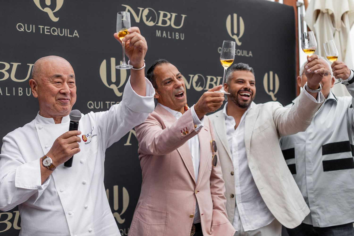 Corporate event photography capturing the owner and key team members toasting at a premium Tequila launch celebration by Tucara Photography.