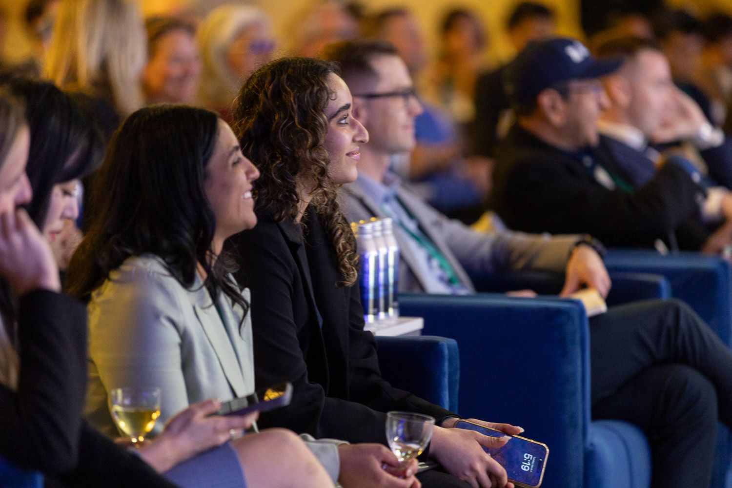 Audience listening to a panel discussion at a corporate summit event.