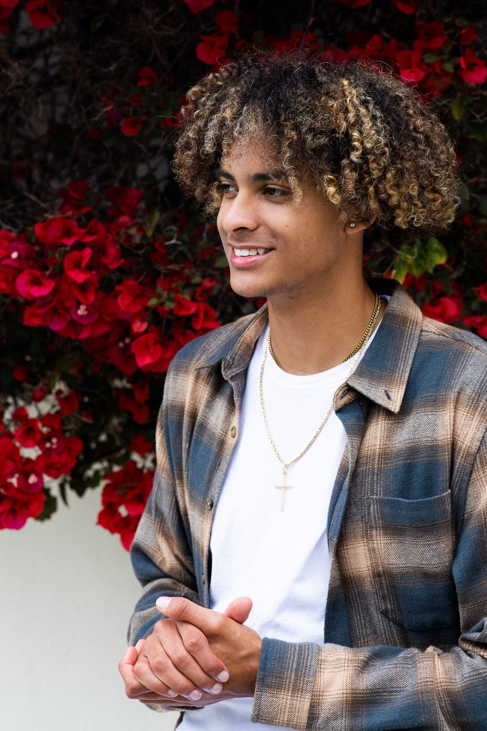 Casual lifestyle portrait of a young man in a flannel button-up shirt.