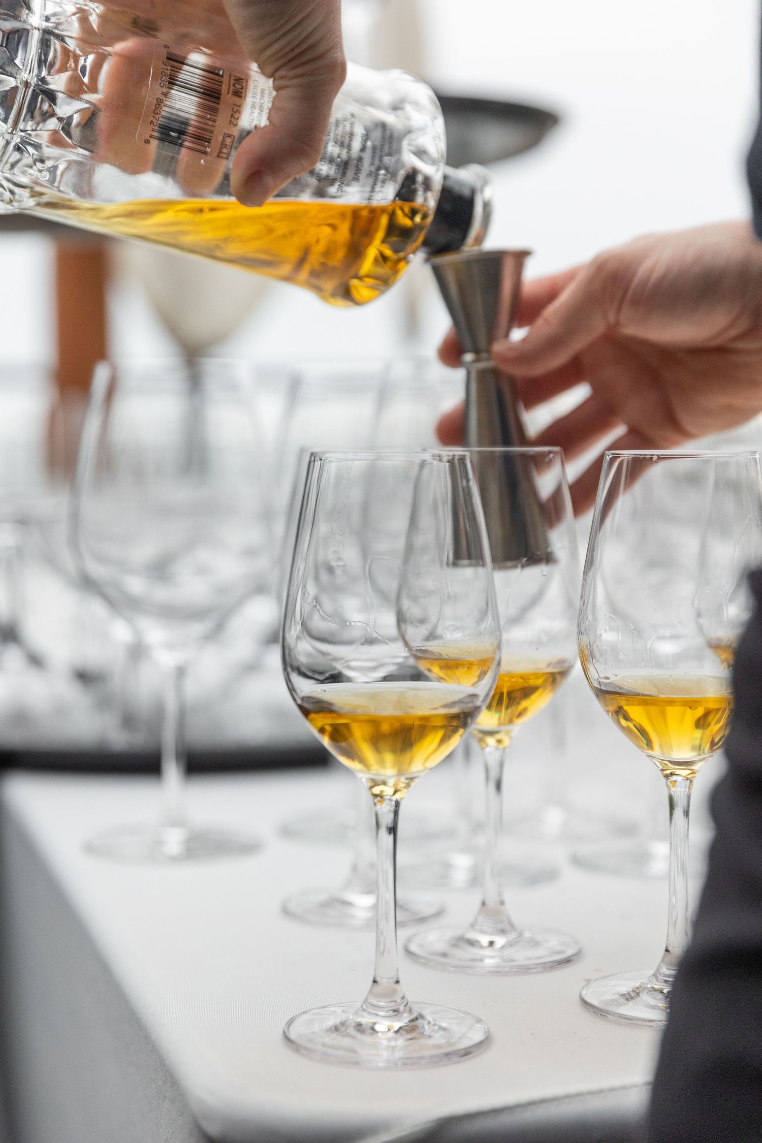 Action documentary photography capturing a premium Tequila pour at a restaurant launch celebration by Tucara Photography.