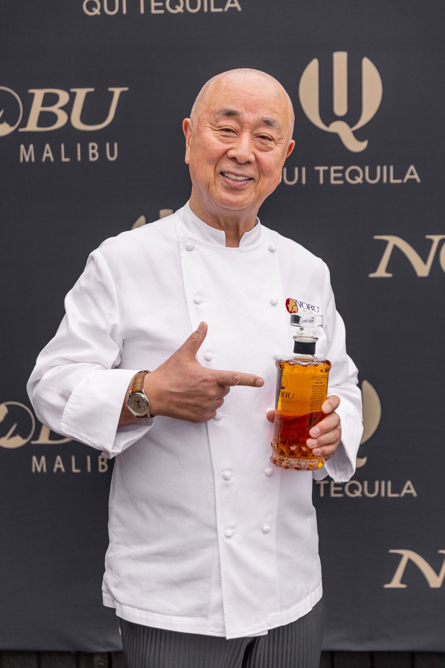 commercial brand portrait of the owner holding a bottle at his premium Tequila launch event by Tucara.