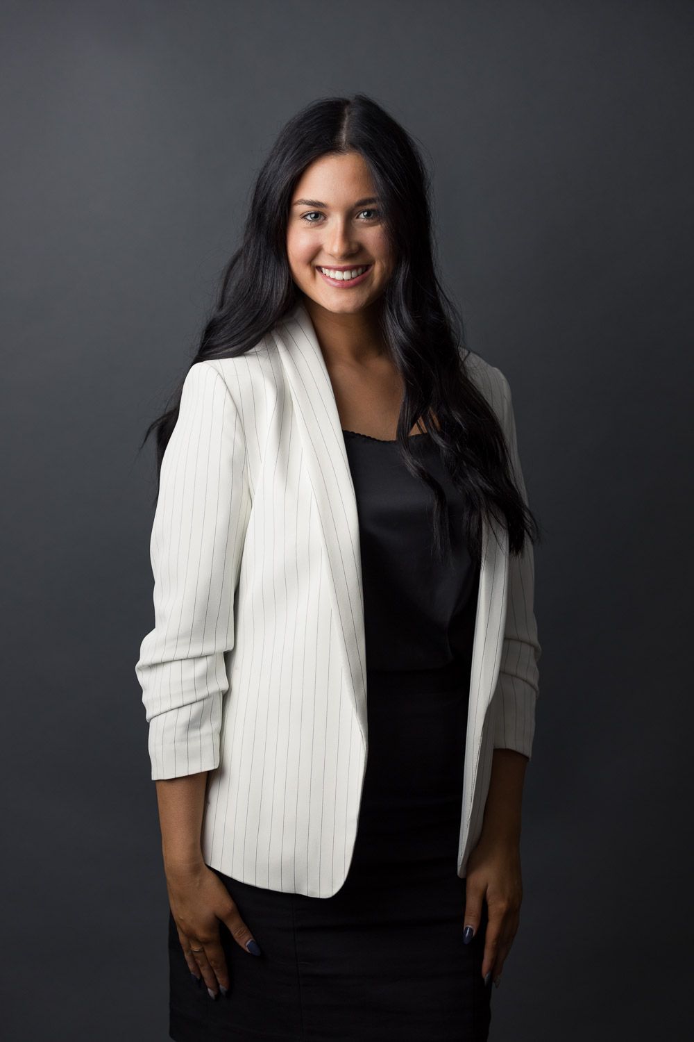 Studio portrait of a women in a white jacket.