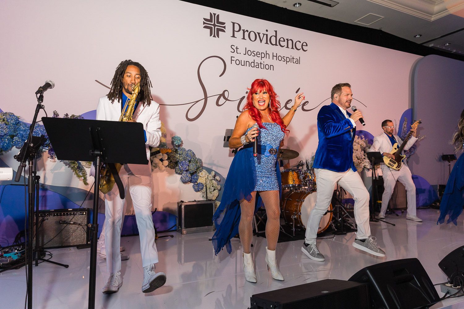Live musical band performing on stage at a corporate gala.
