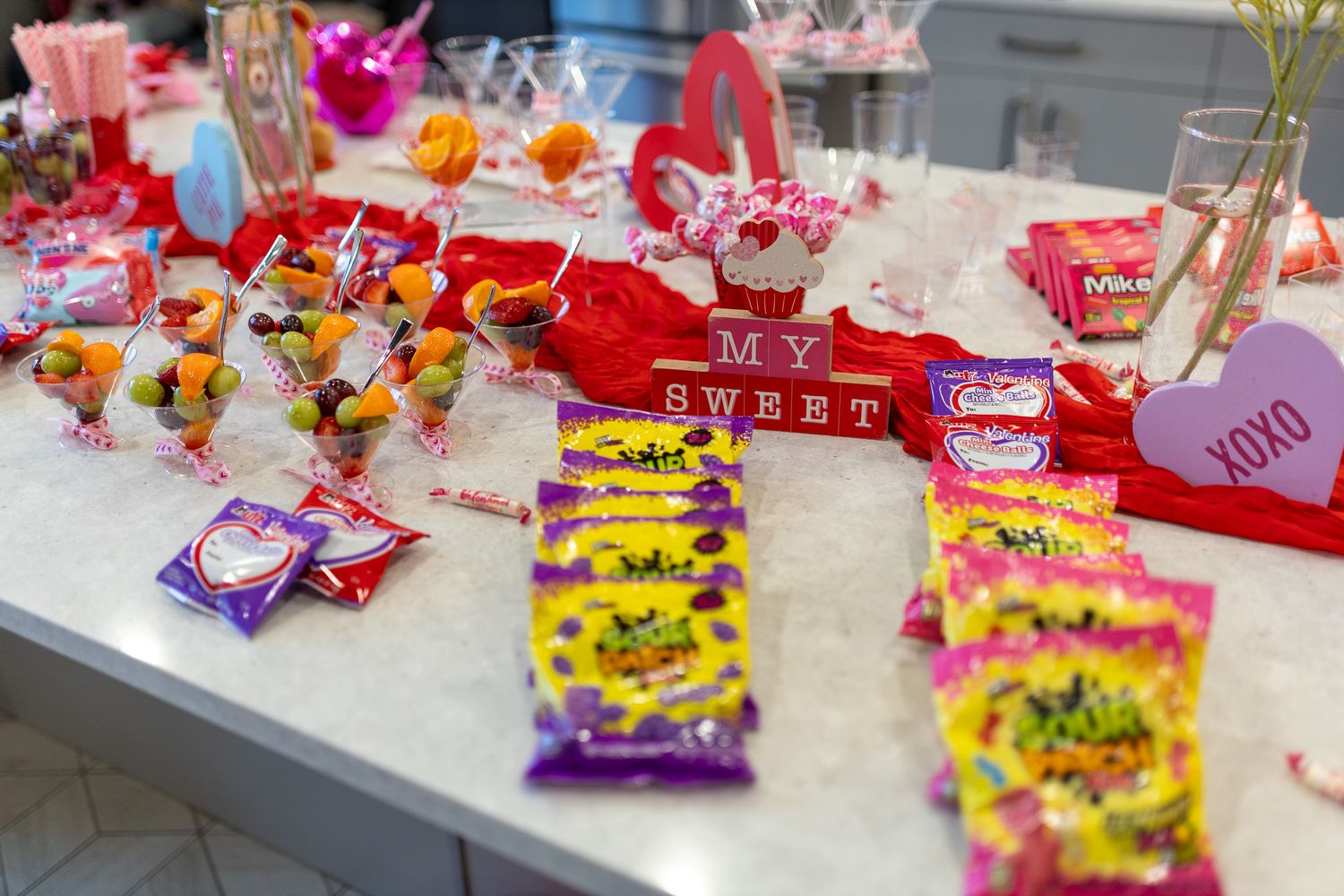This photo features a table with various bags of candy and treats, including some with 