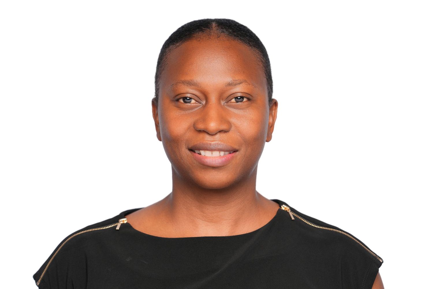 Professional headshot of a smiling woman in a black top against a white background.