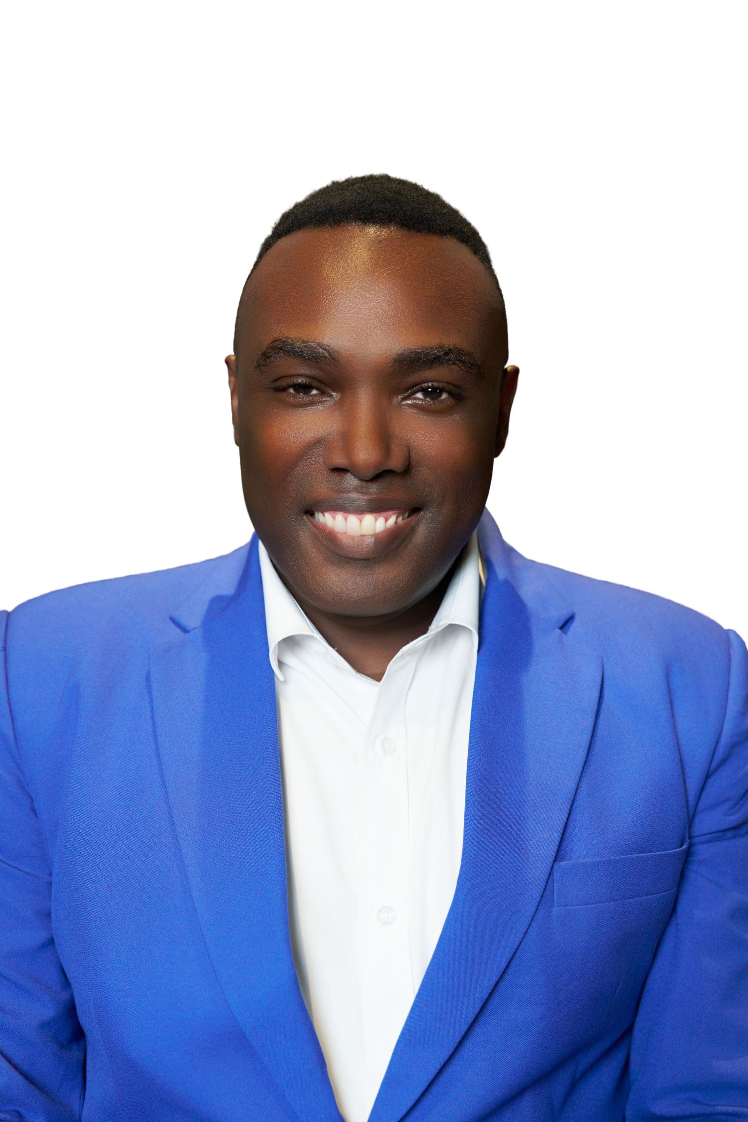 Smiling man in a bright blue blazer and white shirt poses for a professional headshot on white background.