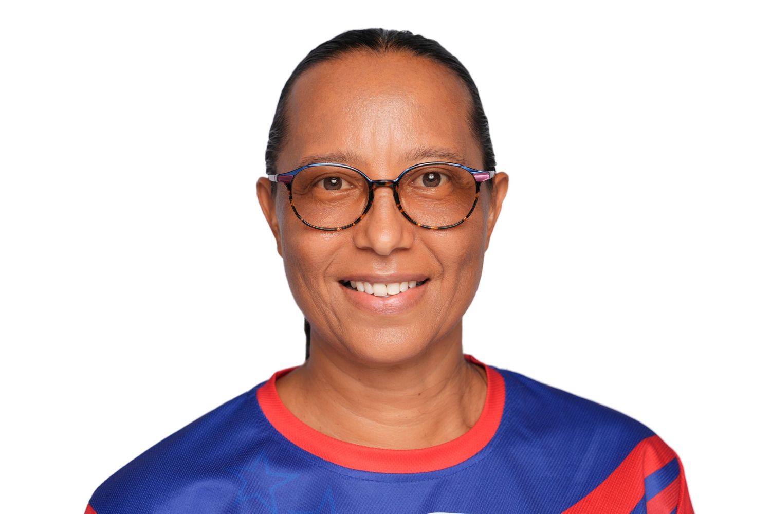 Smiling woman wearing glasses and a blue and red sports jersey against a white background.