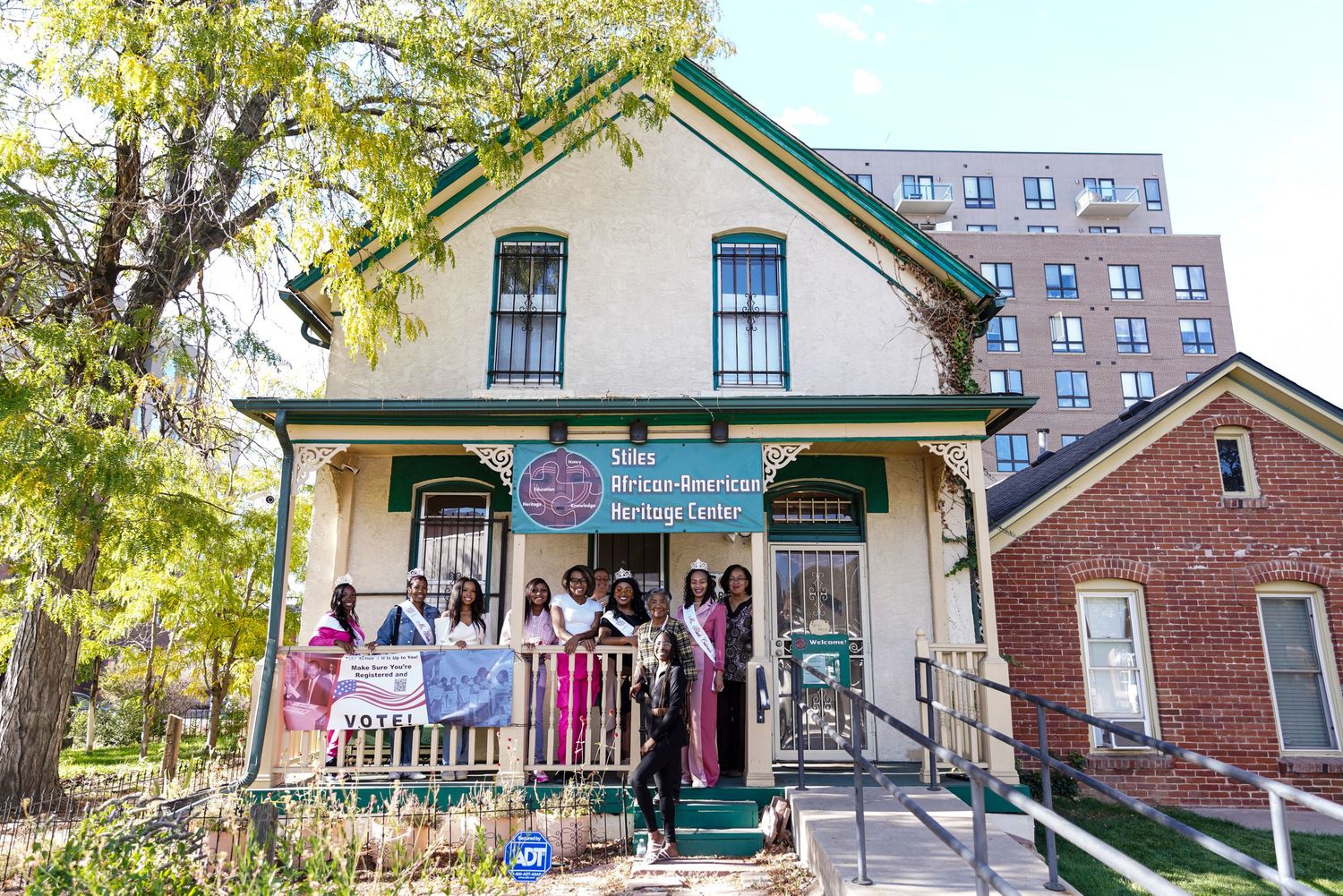 Group of women posing outside the African-American Heritage Center historic building.