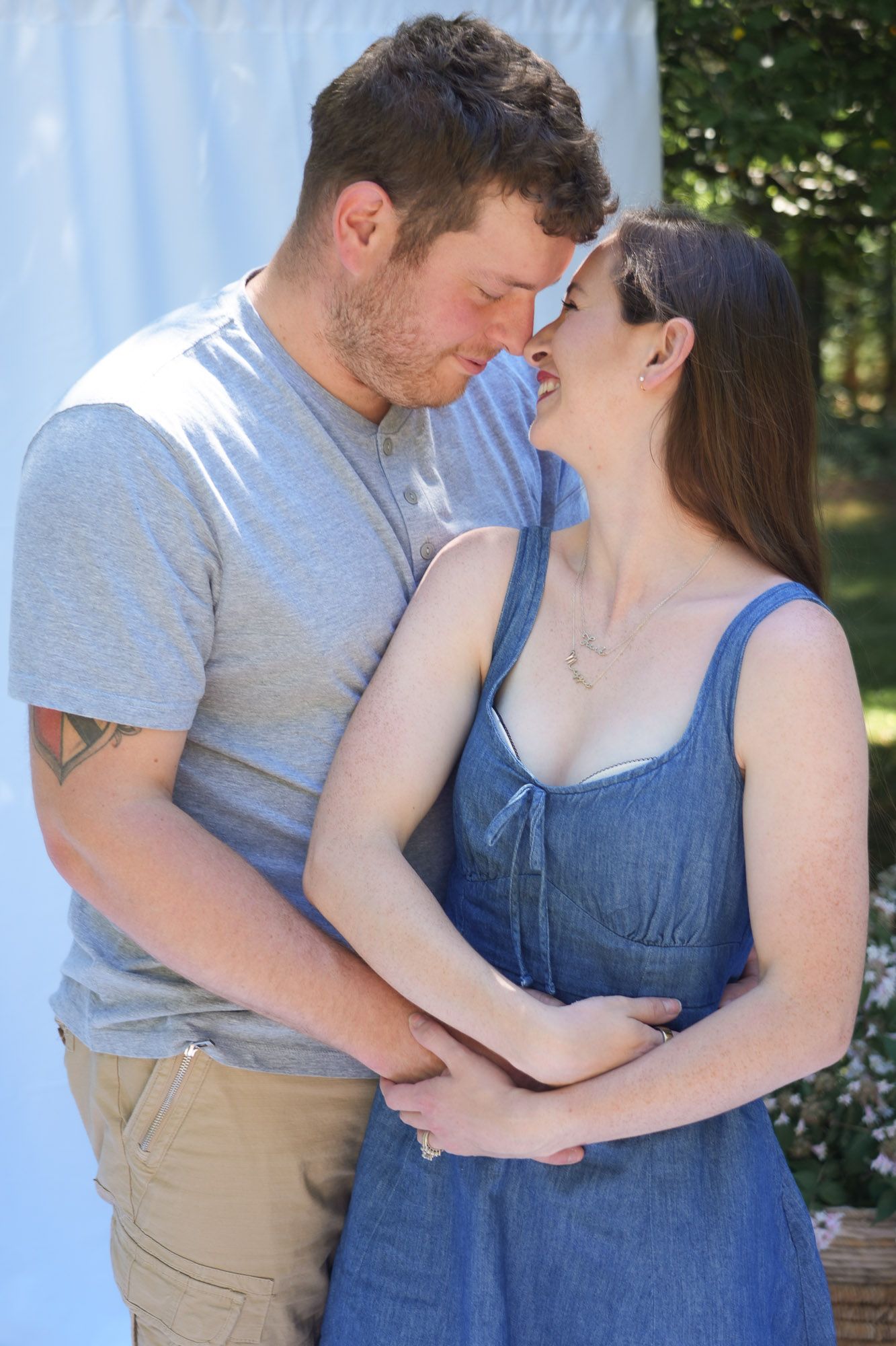 Romantic couple holding hands and sharing an intimate moment in outdoor photo session.