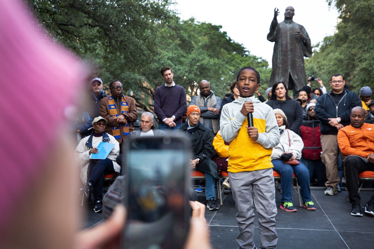 A boy speaks to a crowd