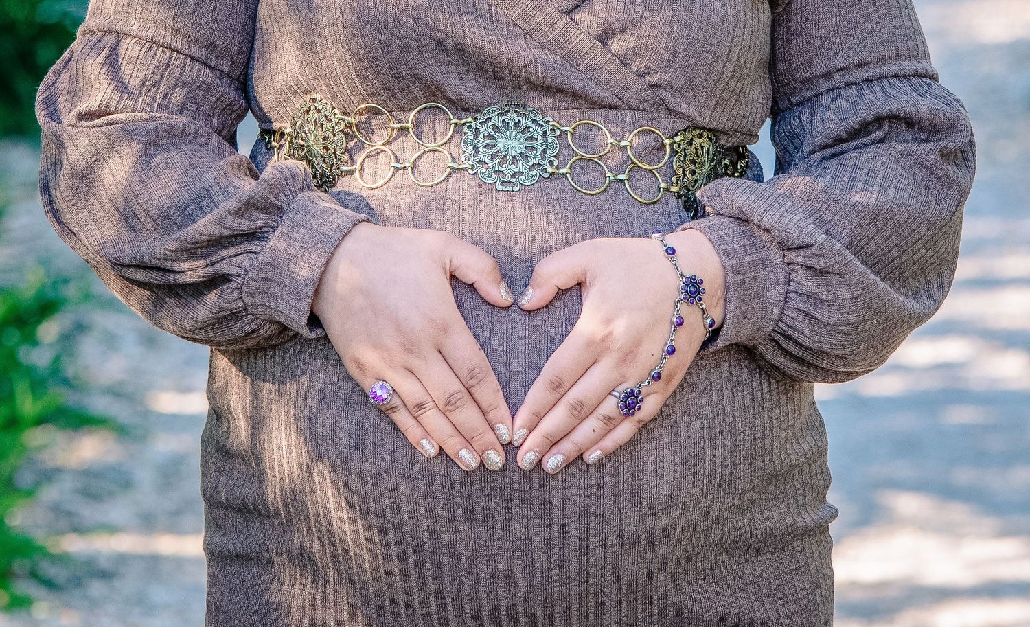 Maternity photo in wooded area near Amherstburg, serene mom holding belly captured by Tasha Cannaday.
