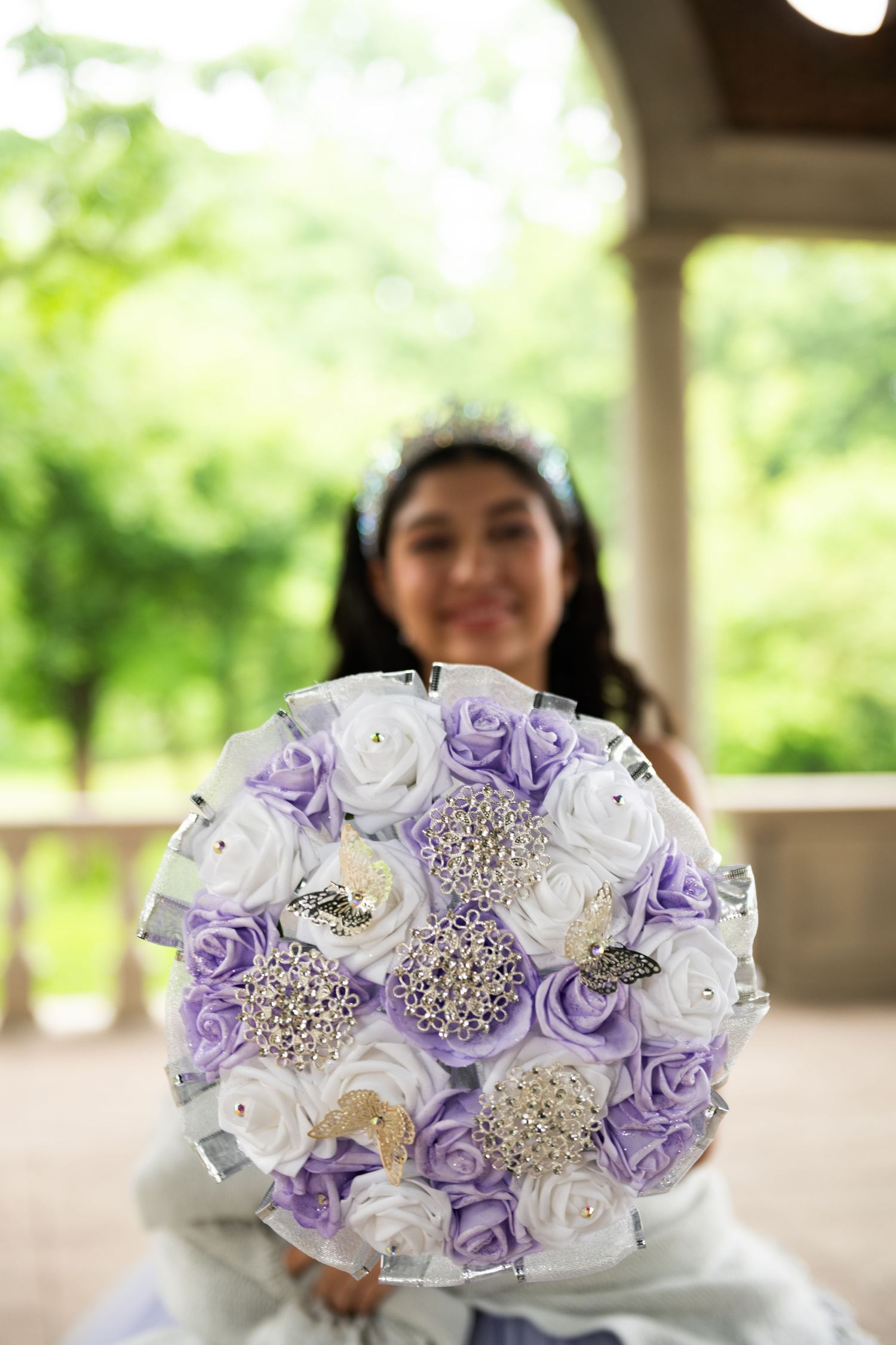 Beautiful bouquet of purple and white roses with crystal accents.