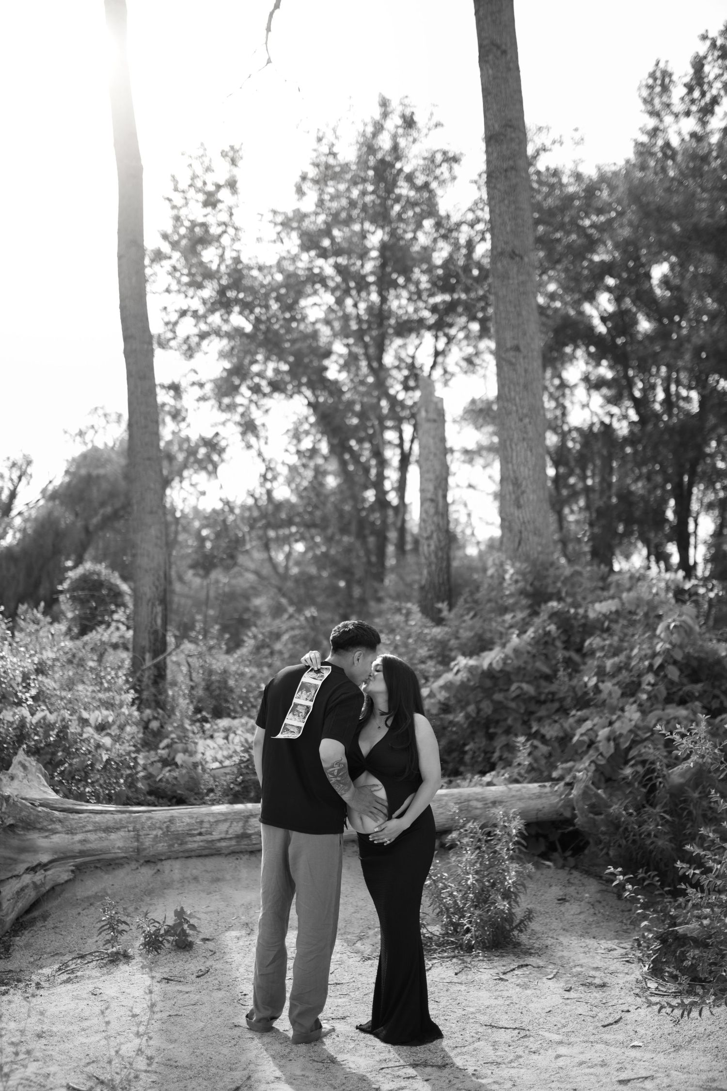 Black and white romantic photoshoot in a wooded forest setting.