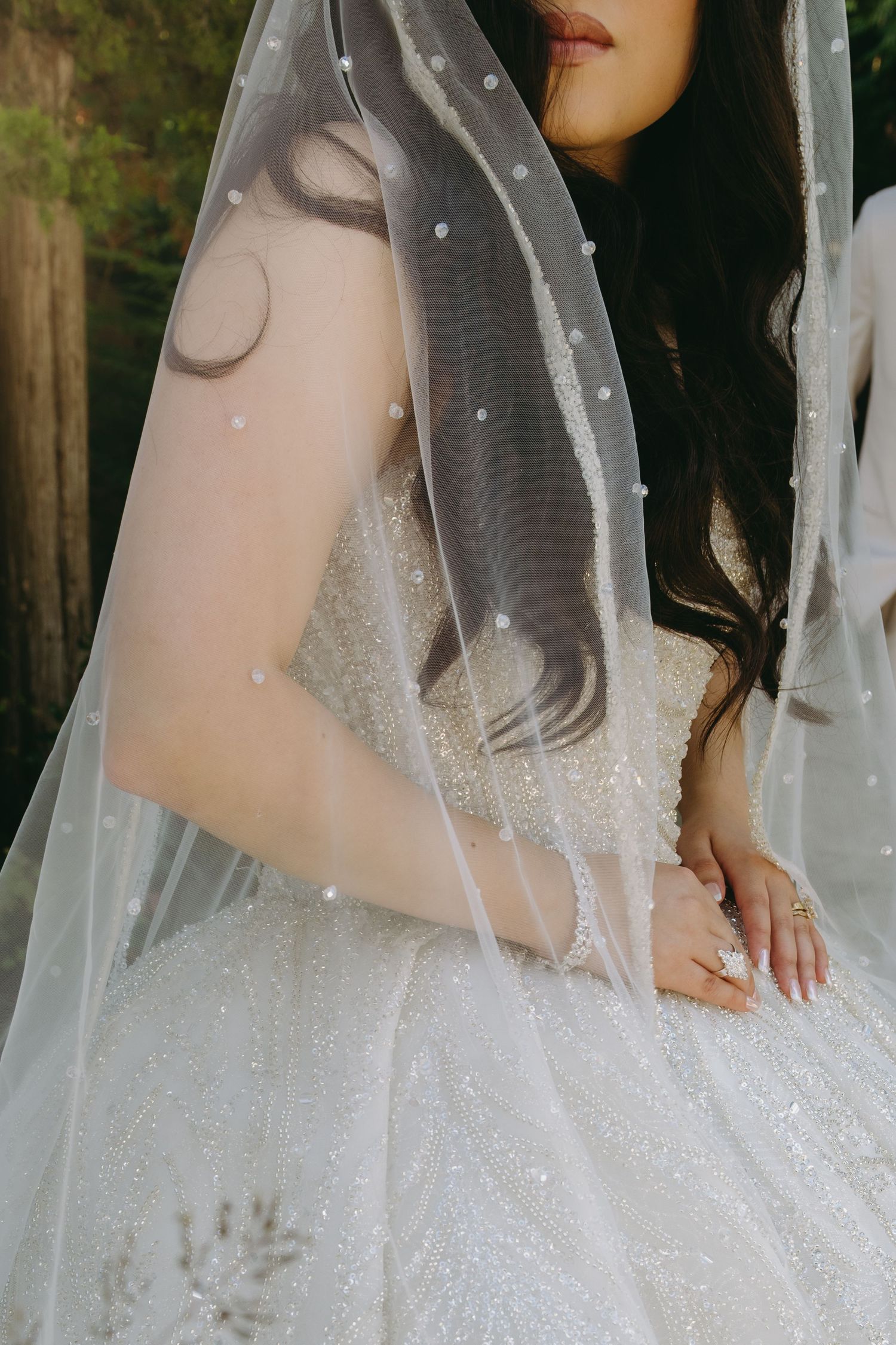 Close-up of delicate bridal veil with pearl details.