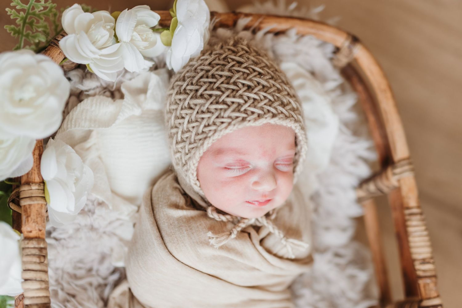 Soft white nursery decor with plush textures and neutral tones creates a cozy atmosphere.